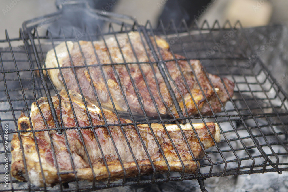 Grilled meat on a barbecue grill.