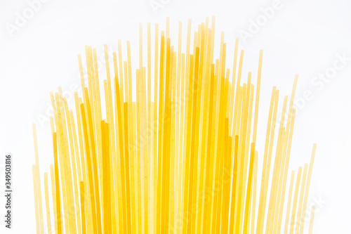 Uncooked Italian spaghetti on the white background