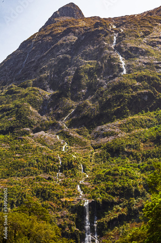 Small waterfall on green mountain. The road to Fiordland. South Island, New Zealand