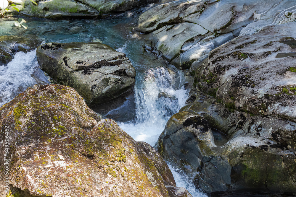 A stream disappearing into a funnel. Funnel Chasm in New Zealand. Stream among stones. South Island