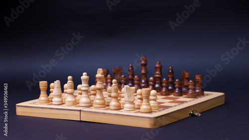 A game of chess, the beginning of a chess game two sides opposite each other.