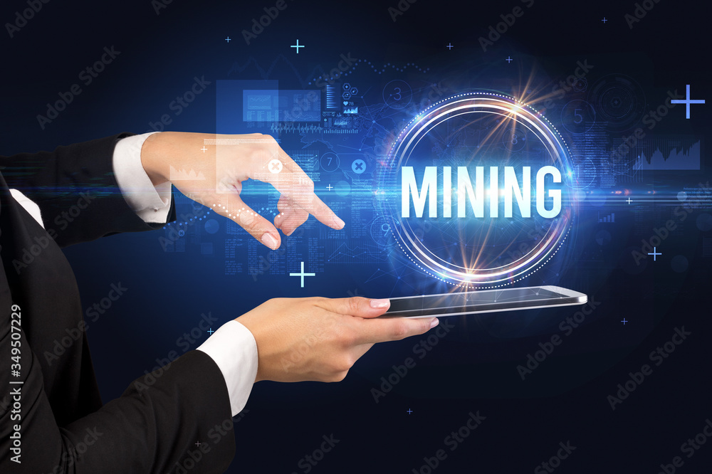Close-up of a touchscreen with MINING inscription, new technology concept Close-up of a touchscreen with MINING inscription, new technology concept