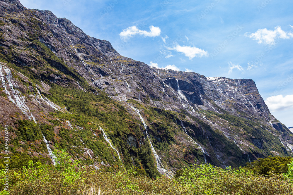 Small waterfalls  from sheer cliffs on the way to Fiordland. South Island, New Zealand