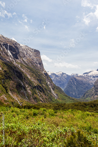 Sheer cliffs and green valley on the way to Fiordland. South Island, New Zealand