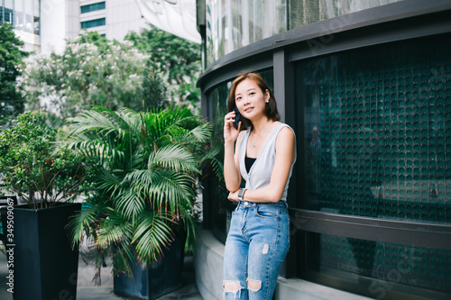 Trendy Asian woman talking on phone