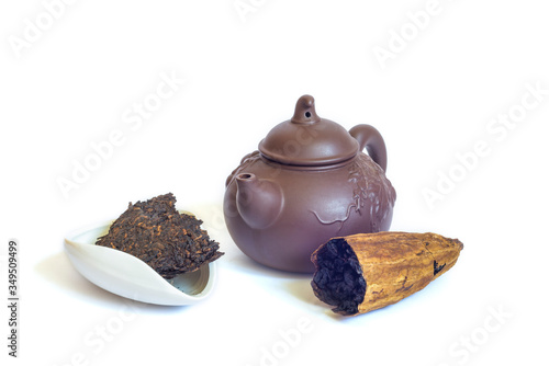 Chinese tea ceremony. Clay teapot with bowl chahe with puer tea and ku gua Oolong in bitter gourd isolated on white background photo