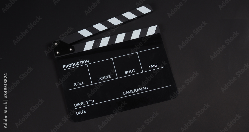 Black Clapperboard or clap board or movie slate use in video production ,film, cinema industry on black background.