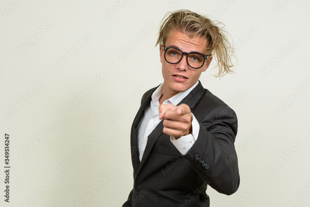 Young blond businessman with eyeglasses pointing at camera Young blond businessman with eyeglasses pointing at camera