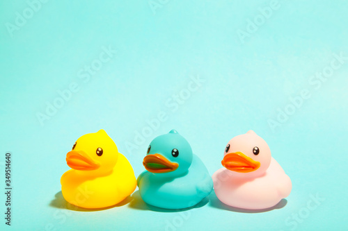 Colorful rubber bath ducks on blue background Fototapet