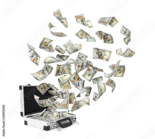 American banknotes flying out suitcase on white background