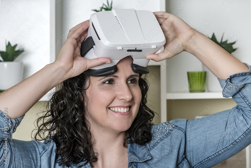 Pleased adult woman with virtual reality glasses in modern office Pleased adult woman with virtual reality glasses in modern office