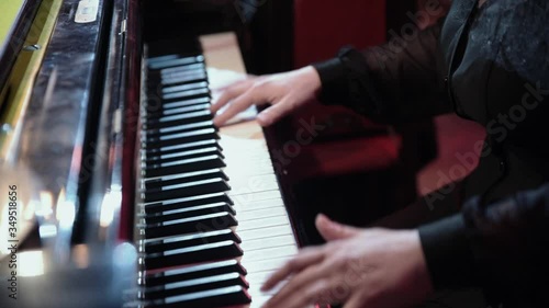 the musician plays the piano and synthesizer close up