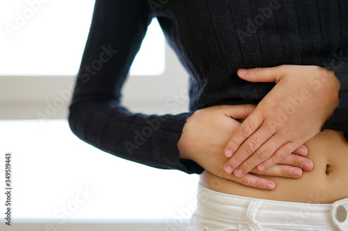 Woman touching her belly with appendicitis pain. Appendicitis concept. photo