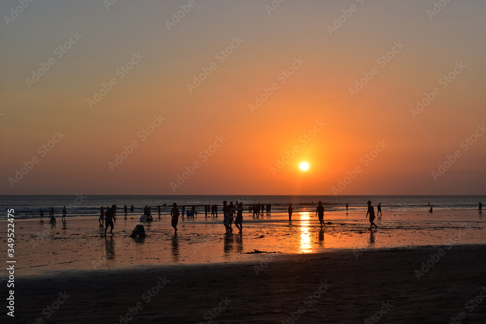Sunset view at the beach. People playing at the beach with sunset background. Bali Indonesia