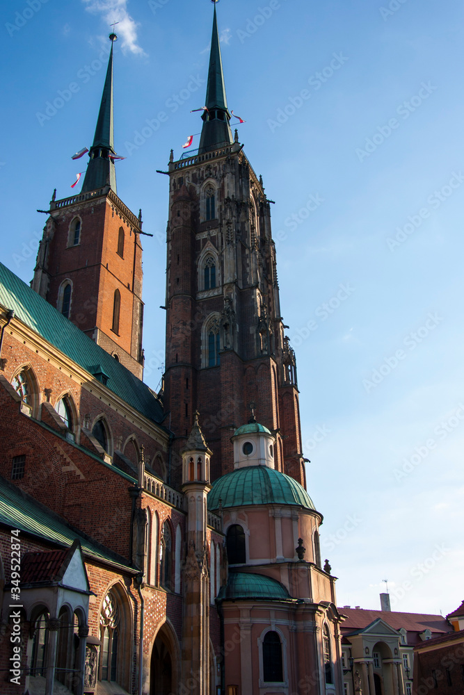 Fototapeta premium church, architecture, cathedral, tower, city, building, europe, old, town, landmark, religion, gothic, travel, poland, tourism, sky, historic, catholic, history, medieval, clock, historical,wroclaw