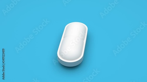 White pills isolated rotating on blue background. Seamless looping. 4K UHD. 3d rendering. 