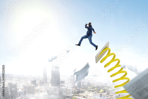 Wallpaper Mural Businessman jumping on springboard . Mixed media Torontodigital.ca