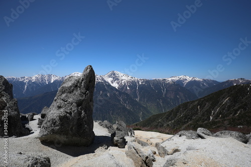 Strange rock with mountains in the background © Satoshi S