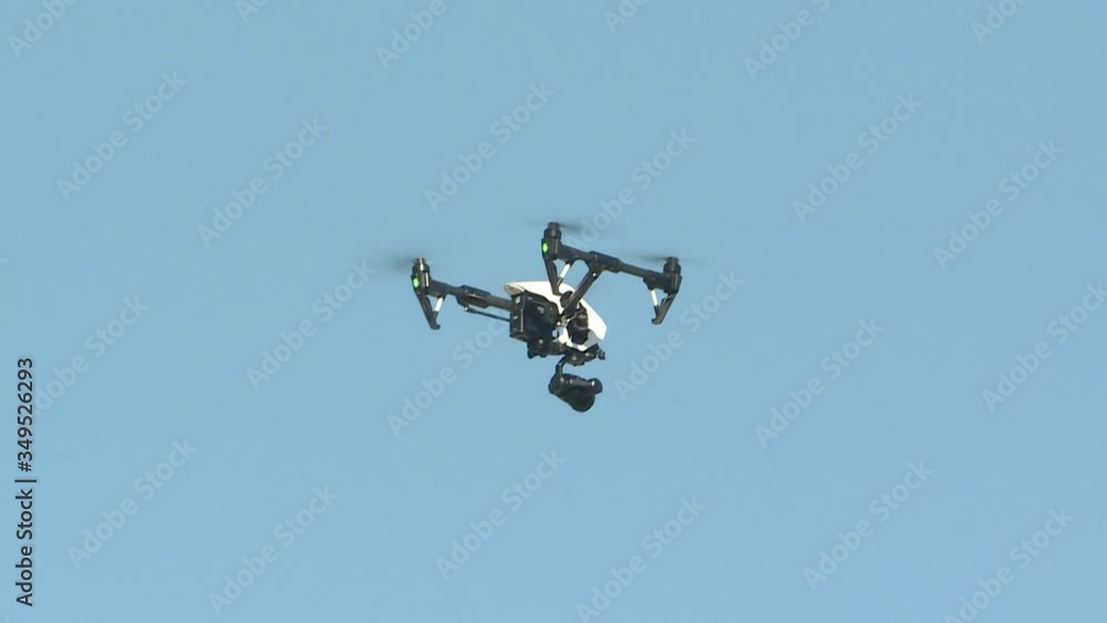 The drone on the background of blue sky. New technologies, an aircraft designed for video shooting and reconnaissance, in agriculture. The drone on the background of blue sky. New technologies, an aircraft designed for video shooting and reconnaissance, in agriculture.