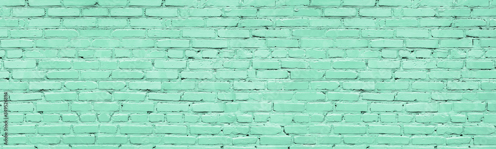 Mint color painted brick wall wide texture. Old pastel green rough brickwork background Mint color painted brick wall wide texture. Old pastel green rough brickwork background
