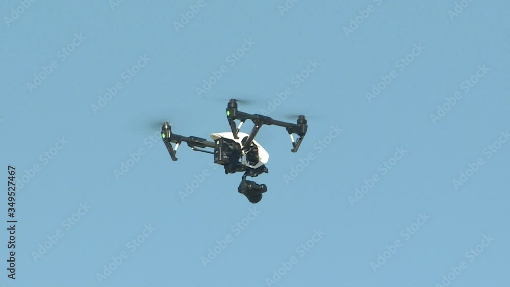 The drone on the background of blue sky. New technologies, an aircraft designed for video shooting and reconnaissance, in agriculture. The drone on the background of blue sky. New technologies, an aircraft designed for video shooting and reconnaissance, in agriculture.