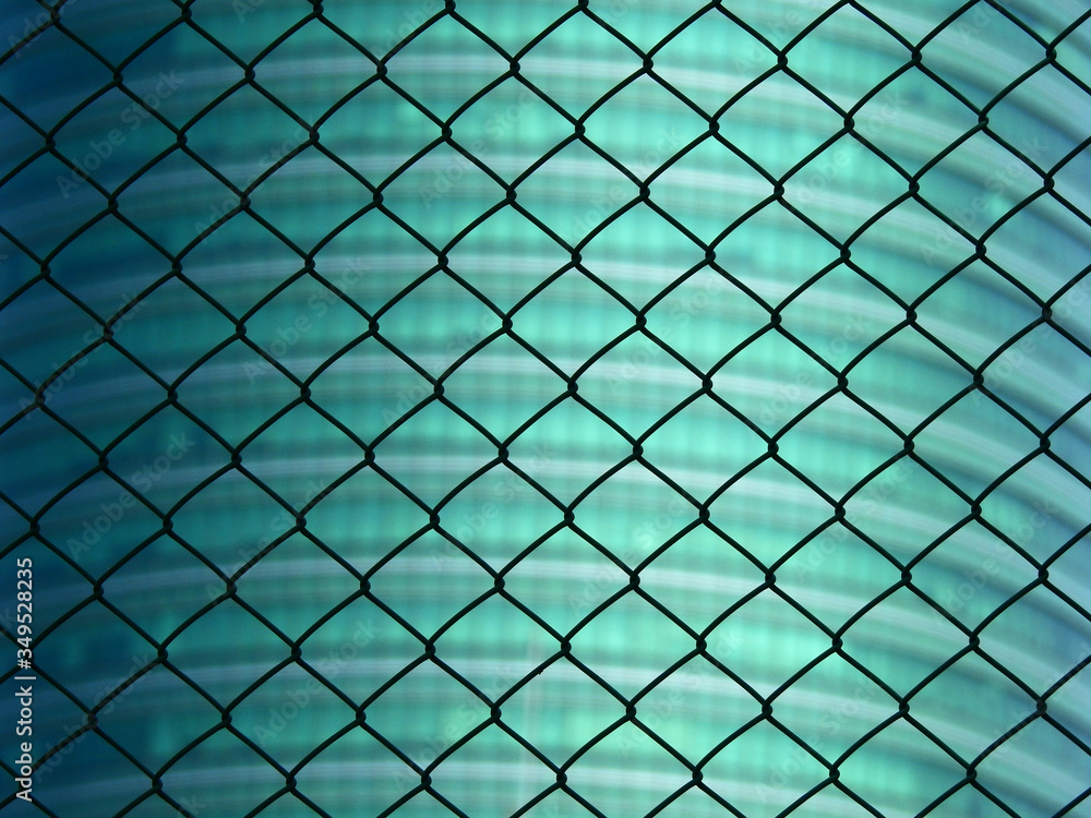 Fototapeta premium wire mesh of fence with building background