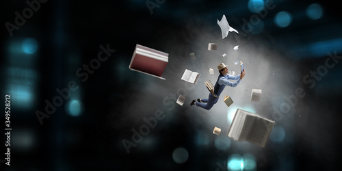 Flying man with a book