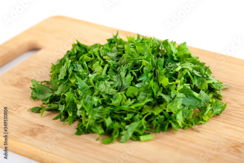 chopped parsley leaf on wooden a board isolated on white background