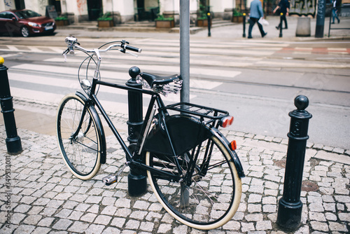 Modern bicycle parked on sidewalk