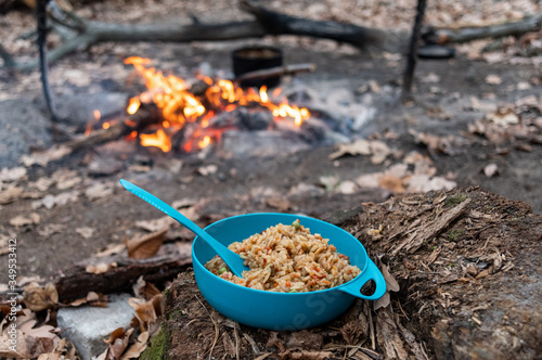 Campfire in the forest. Cooking at the stake in the park. Eat near the fire. Bonfire and Italian paella.