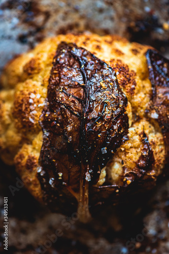Roasted Head of Cauliflower with spices in a vintage metal roasting pan