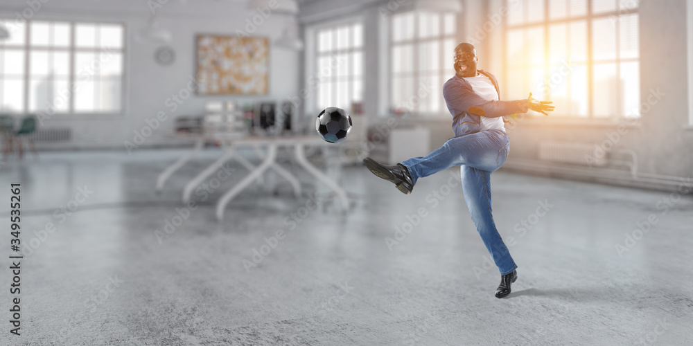 Fototapeta premium Black man plays his best soccer match. Mixed media