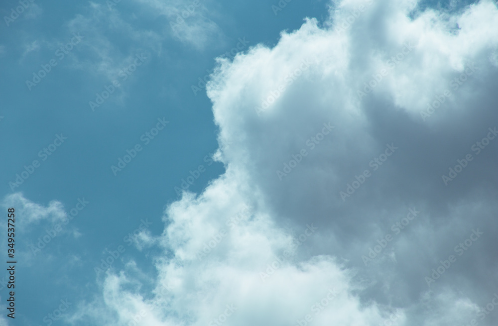 Fluffy clouds cover the summer blue sky Fluffy clouds cover the summer blue sky