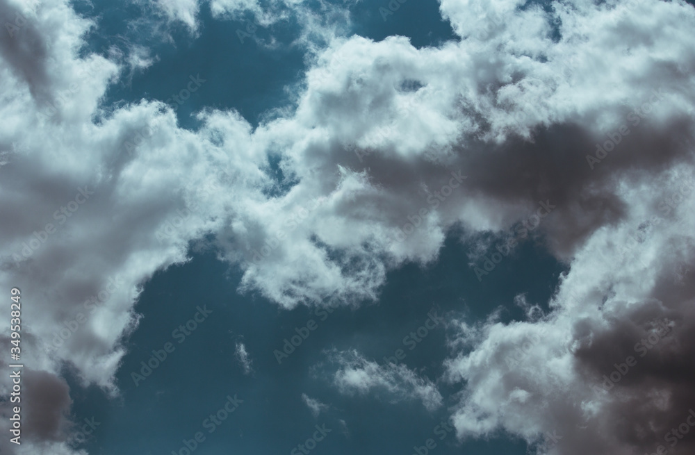 Fototapeta premium Fluffy clouds cover the summer blue sky