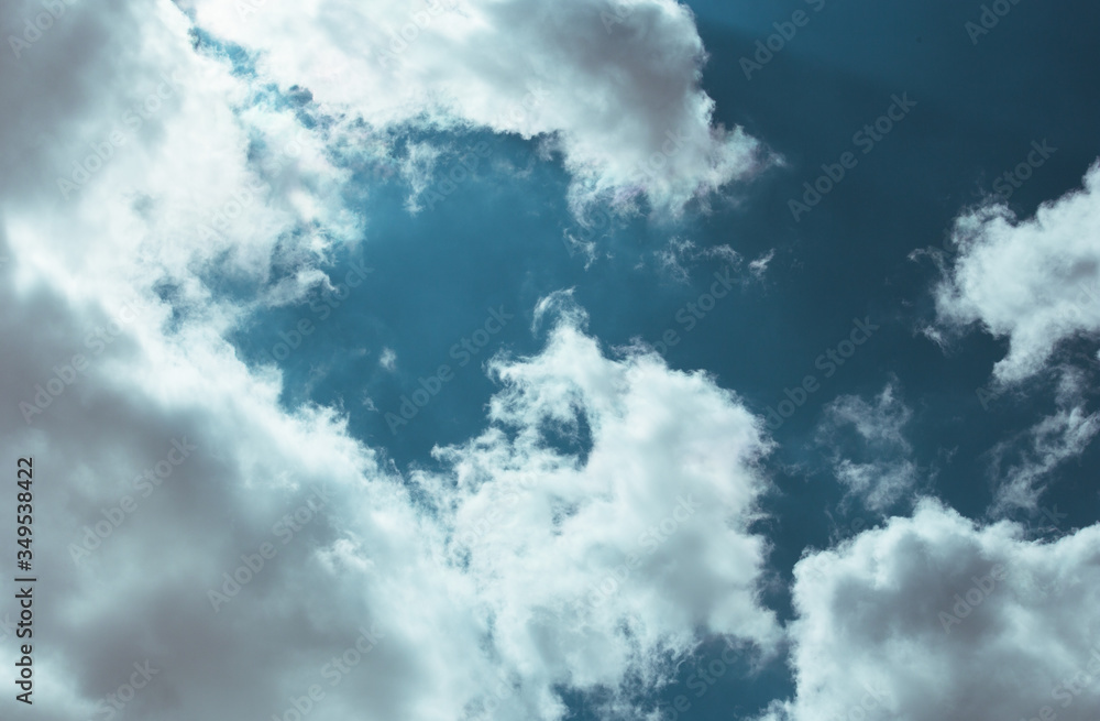 Fluffy clouds cover the summer blue sky Fluffy clouds cover the summer blue sky