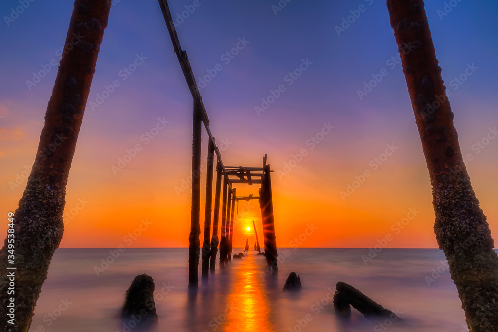 Beautiful sunset scenery with old wooden bridge at khao pilai beach, Phang Nga in Thailand.