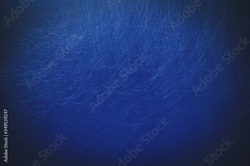 Scratched deep blue metal background as copyspace with vignetting photo