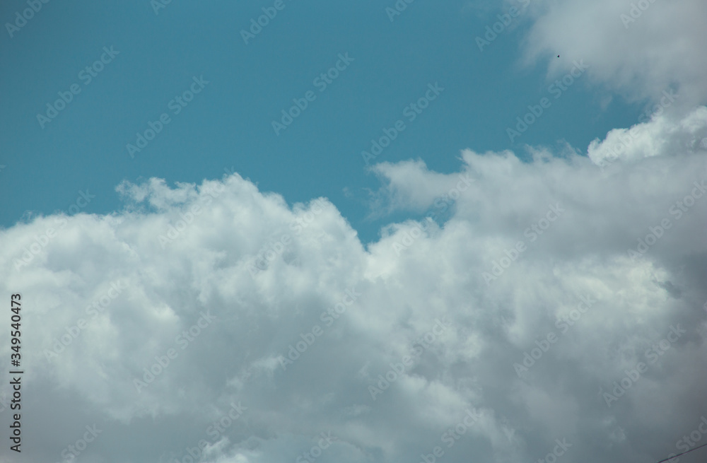 Fluffy clouds cover the summer blue sky Fluffy clouds cover the summer blue sky