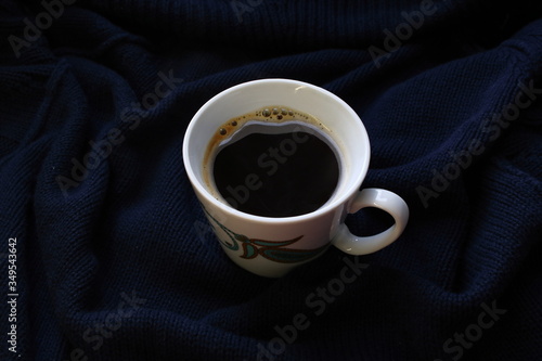 Konstfotografi a Cup of coffee on a dark blue blanket