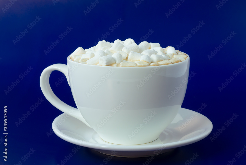 cup of coffee with marshmallows on a blue background. cup of coffee with marshmallows on a blue background.