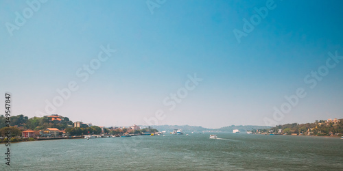 Panaji, Goa, India. Water Navigation On The Mandovi River. Ships Floating On River photo
