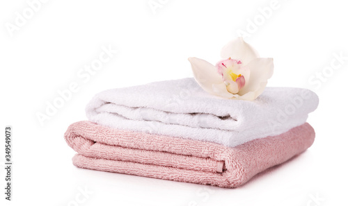 Bath towels with orvhid flower isolated on white