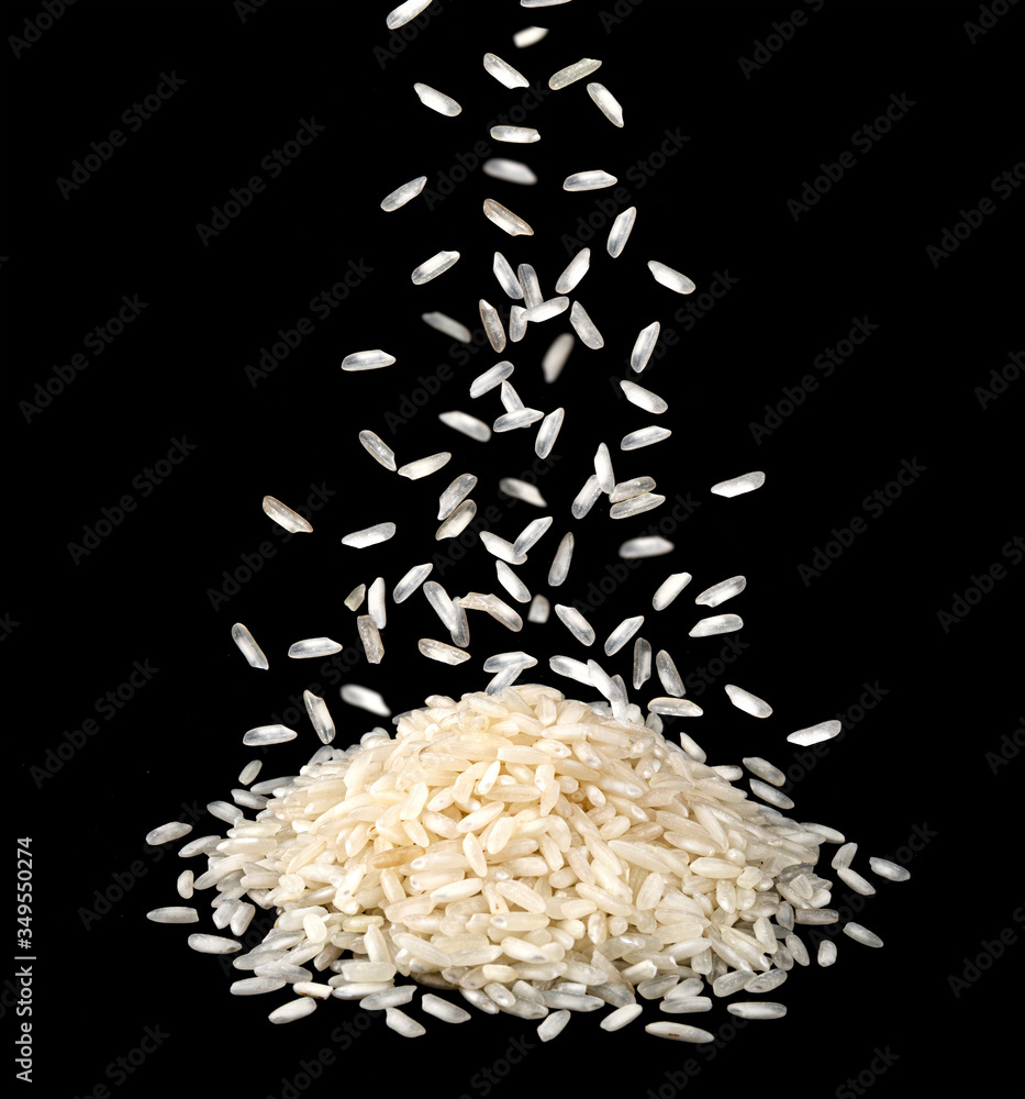 Falling dry rice grains isolated on black background Falling dry rice grains isolated on black background
