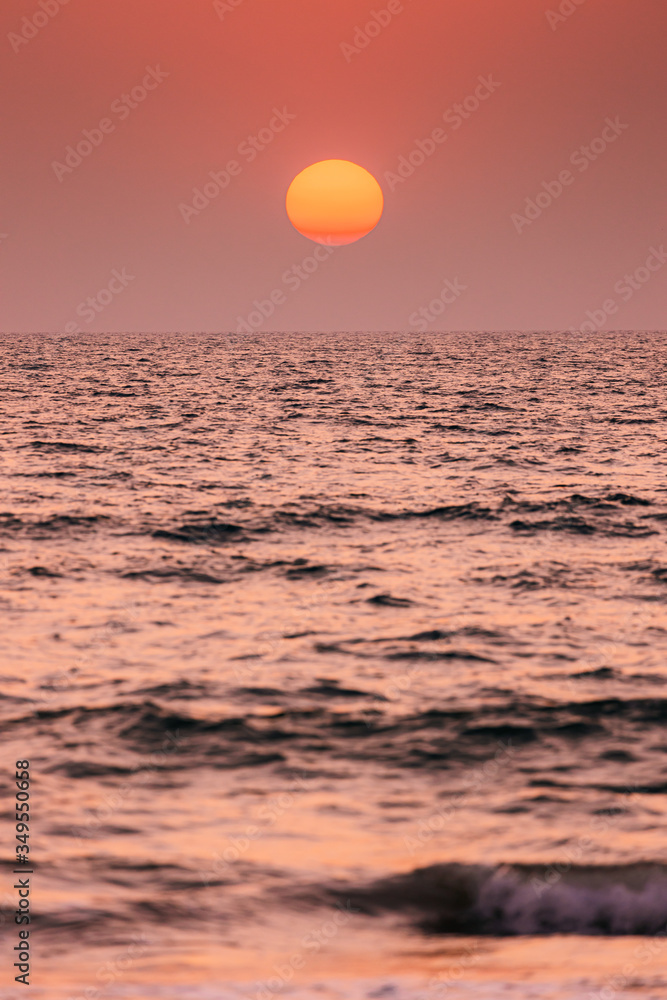 Natural Color Sunset Sunrise Sky Over Sea. Seascape With Shining Setting Sun On Sea Horizon