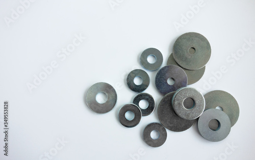 Metal washers for bolts of different sizes on white isolate