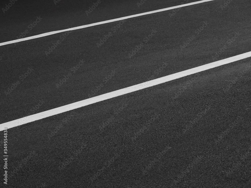 dark asphalt road with white line of lane