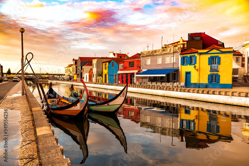 Aveiro, Portugal, Traditional colorful Moliceiro boats docked in the water canal among historical buildings. photo