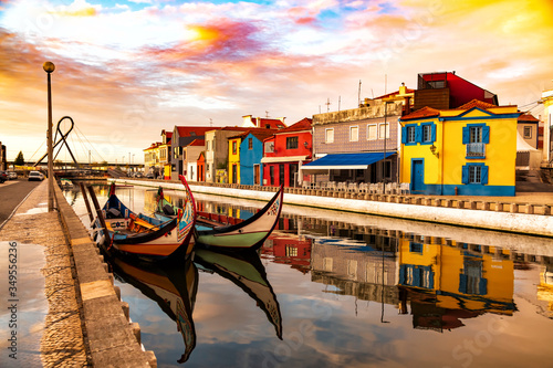 Obraz na płótnie Aveiro, Portugal, Traditional colorful Moliceiro boats docked in the water canal among historical buildings. w salonie