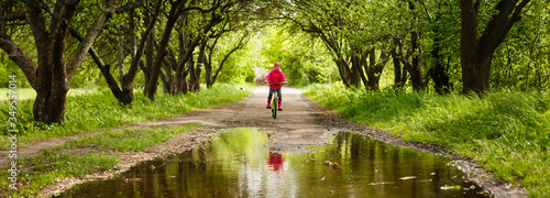 little girl riding bike in water puddle photo