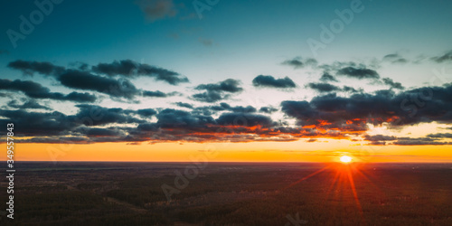 Aerial View Of Sunshine In Sunrise Bright Dramatic Sky. Scenic Colorful Sky At Dawn. Sunset Sky Above Autumn Forest Landscape In Evening. Top View From High Attitude